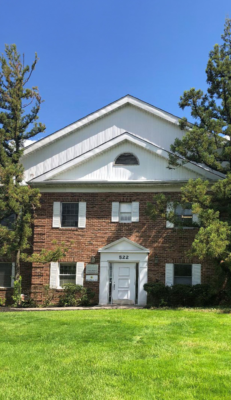 The image shows a modern dental or medical office interior with a dental chair, equipment, and a clean, professional environment.